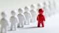 Red Figure Stands out From the White Crowd on a White Background Royalty Free Stock Photo