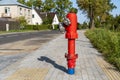 Single red fire hydrant standing on city street Royalty Free Stock Photo