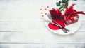 A single red rose with red heart message card on the white dish Royalty Free Stock Photo