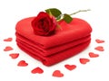 Single red rose on stacked hearts with scattered hearts Royalty Free Stock Photo