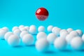 Single red sphere floating above group or team of white spheres over blue background, team, leadership or individuality concept Royalty Free Stock Photo