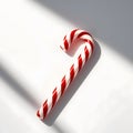 Single red and white striped candy cane with precise and evenly spaced stripes, isolated on a bright and pristine white background Royalty Free Stock Photo