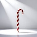 Single red and white striped candy cane with precise and evenly spaced stripes, isolated on a bright and pristine white background Royalty Free Stock Photo