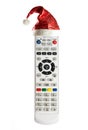 Single remote control with christmas hat isolated on white background Royalty Free Stock Photo