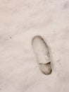 single right foot footprint in snow floor background close up