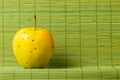 Single ripe fresh bright yellow apple over green background Royalty Free Stock Photo