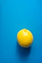 Single Ripe Juicy Whole Lemon on Blue Background. Vitamins Healthy Diet Summer Superfoods