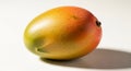 Single ripe mango fruit with vibrant gradient of green yellow and red hues on a clean white background with shadow Royalty Free Stock Photo
