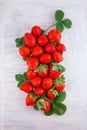 Single ripe strawberry on white wooden plate kitchen table Royalty Free Stock Photo