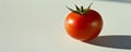 Single ripe tomato on white background with shadow Royalty Free Stock Photo