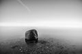 Single rock in the water by the sea