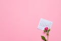 single rose flower lying on calendar page showing february 2020, valentin, valentine card concept, calendar, pink background, Royalty Free Stock Photo