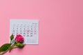 single rose flower lying on calendar page showing february 2020, valentin, valentine card concept, calendar, pink background, Royalty Free Stock Photo