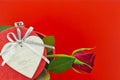 Single rose on gift box and heart medallion