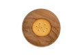 Single round cracker in wooden plate Royalty Free Stock Photo