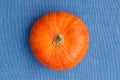 Single Round Pumpkin View from Above on blue Background with copy space.