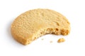 Single round shortbread biscuit with crumbs and bite missing. In