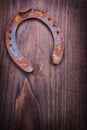 Single rusted horseshoe on vintage dark wooden