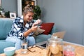 Single sad woman complaining holding a pregnancy test sitting on a couch in the living room at home, Stressed female, Positive or Royalty Free Stock Photo