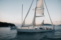 A single sailboat anchored in a quiet bay