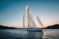 A single sailboat floating in a calm bay