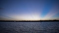 Rays of colorful sun fill the sky at sunset off the east coast of Florida Royalty Free Stock Photo