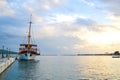 Single sailing boat in Marmaris seaport during sunset. Sea voyage Royalty Free Stock Photo