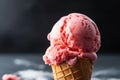 a single scoop of strawberry gelato in a cone