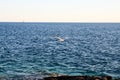 Single seagull flying across a blue sky. Beautiful white Seagull flying with spread wings above the sea. Birds in nature. Seagull Royalty Free Stock Photo