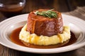 single serving of smoked beef brisket with mashed potatoes and gravy
