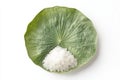 A single serving of white rice carefully placed on a large green lotus leaf The leaf is positioned on a white background Royalty Free Stock Photo