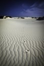 Solitary set of footprints through sand dunes with ripple effect on sand. Corralejo, Fuerteventura.
