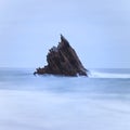 Single sharp rock on the middle of the sea