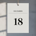 A single sheet calendar hangs by a string against a blurred background Royalty Free Stock Photo