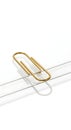 Golden Paper Clip on White Surface Royalty Free Stock Photo