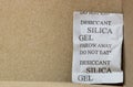 Single Silica gel packet in the bottom corner of a cardboard box.