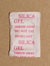 Single Silica gel packet isolated in a cardboard box, flat lay format.