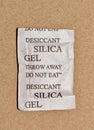 Single Silica gel packet isolated in a cardboard box, flat lay format.