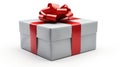 Single silver christmas gift wrapped in red ribbon and bow angled view Royalty Free Stock Photo