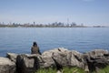 Single sitting on the park bench with Toronto cityscape as a background