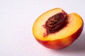 Single slice of peach nectarine fruit with seed on white background, copy space, angle view Royalty Free Stock Photo