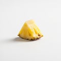 A single slice of pineapple (Ananas comosus) rests on a white surface Royalty Free Stock Photo
