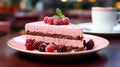 A single slice of Rasberry mousse cake in a red plate on table Royalty Free Stock Photo
