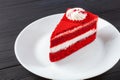 Single Slice Red Velvet Cake On White Plate on dark wooden table. Royalty Free Stock Photo