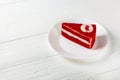 Single Slice Red Velvet Cake On White Plate on white wooden table. Royalty Free Stock Photo