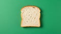 A single slice of white bread is centered on a solid green background Royalty Free Stock Photo