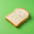 A single slice of white bread is placed on a bright green background Royalty Free Stock Photo
