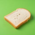 A single slice of white bread is placed on a vibrant green background Royalty Free Stock Photo