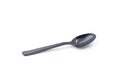 Single small black plastic baby teaspoon isolated from white background Royalty Free Stock Photo