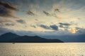 Single small boat, and mountain silhouettes, Howe Sound near Vancouver, Canada Royalty Free Stock Photo